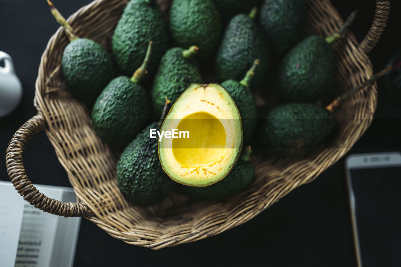 High angle view of avocados in basket on table