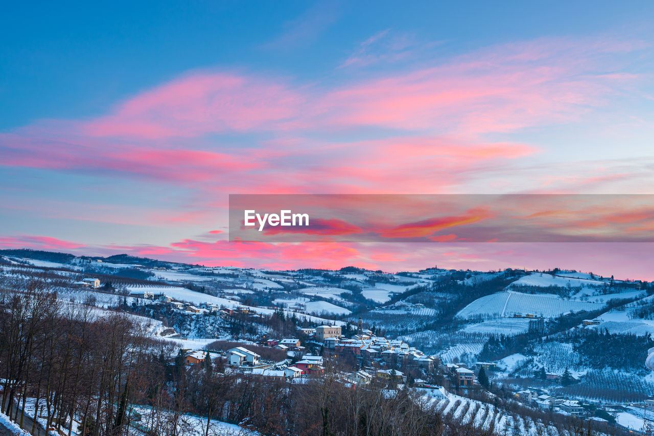 SCENIC VIEW OF SNOWCAPPED MOUNTAINS DURING SUNSET