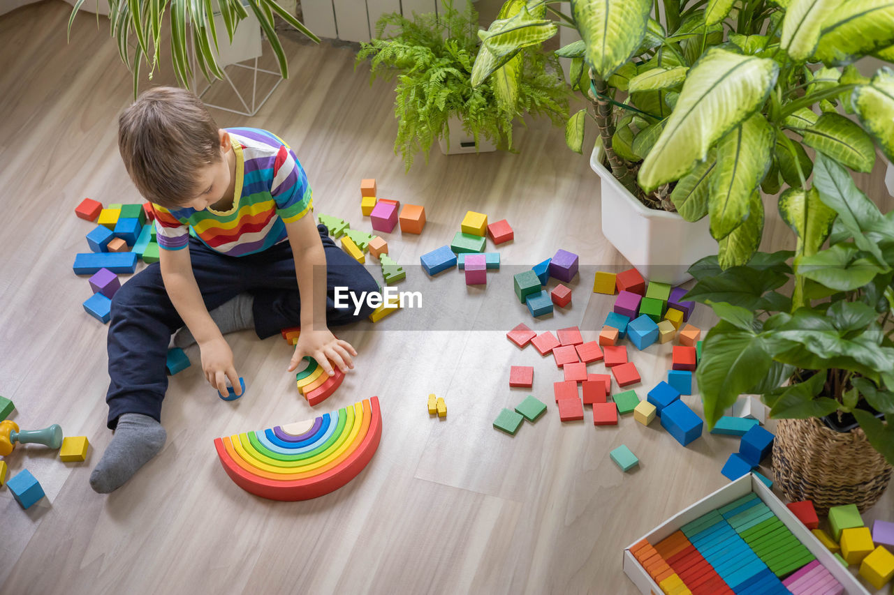 high angle view of boy playing with toy on table