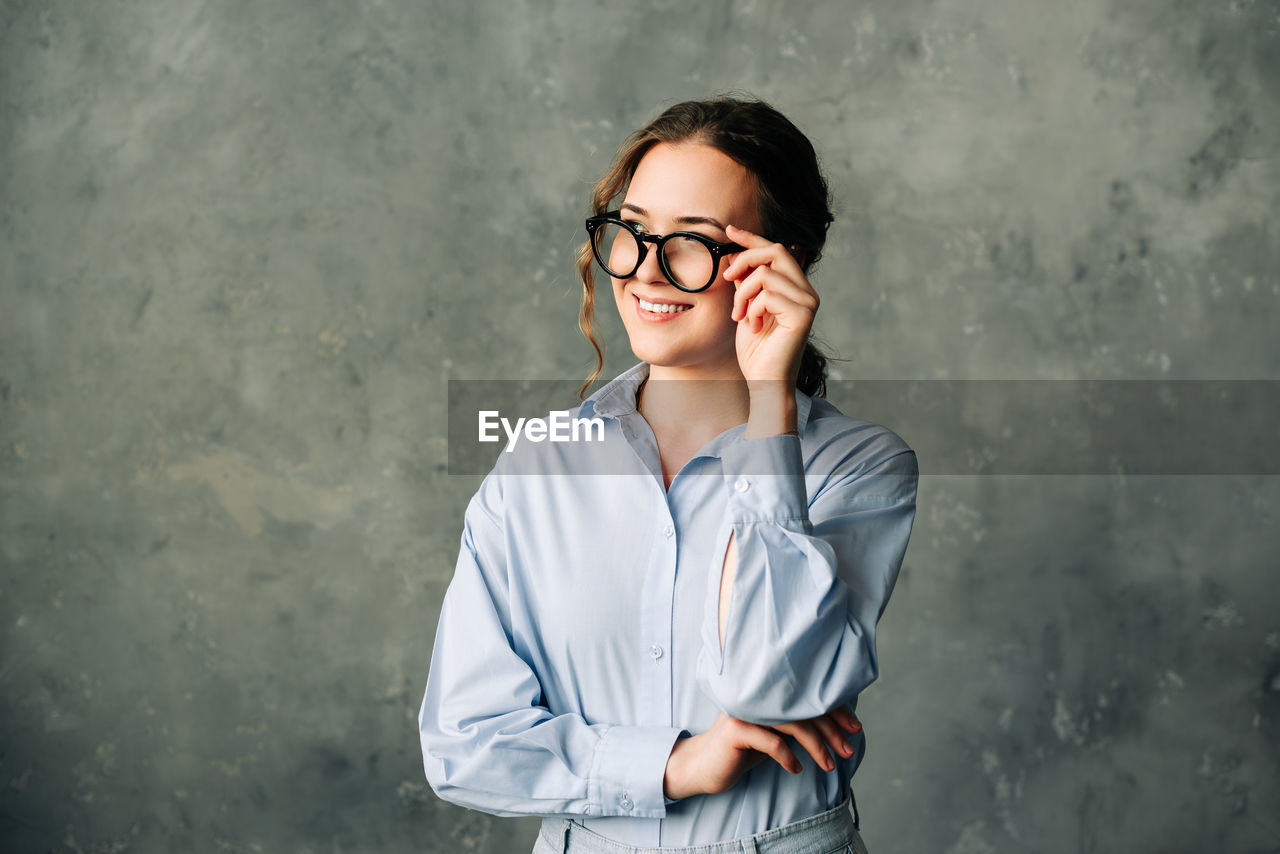 Smiling businesswoman in office. cheerful young woman in glasses, smiling and laughing while
