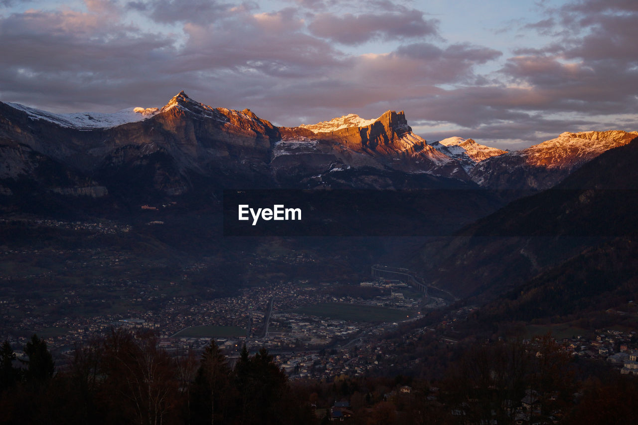 Scenic view of snowcapped mountains against sky during sunset