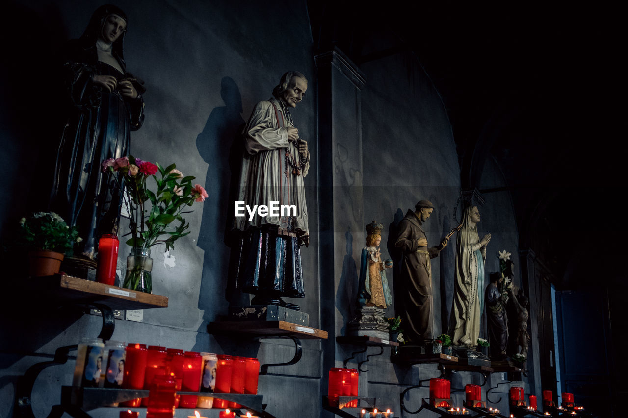 LOW ANGLE VIEW OF BUDDHA STATUE AGAINST WALL