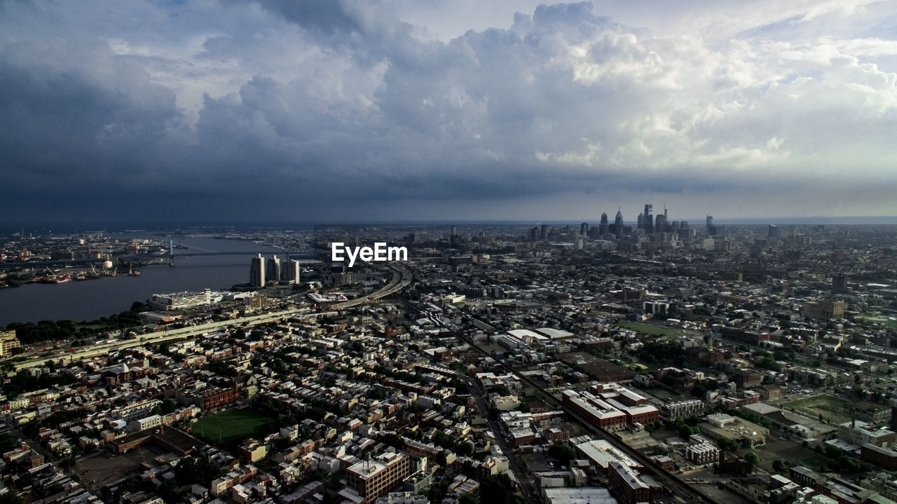 Aerial view of cityscape against cloudy sky in stormy weather