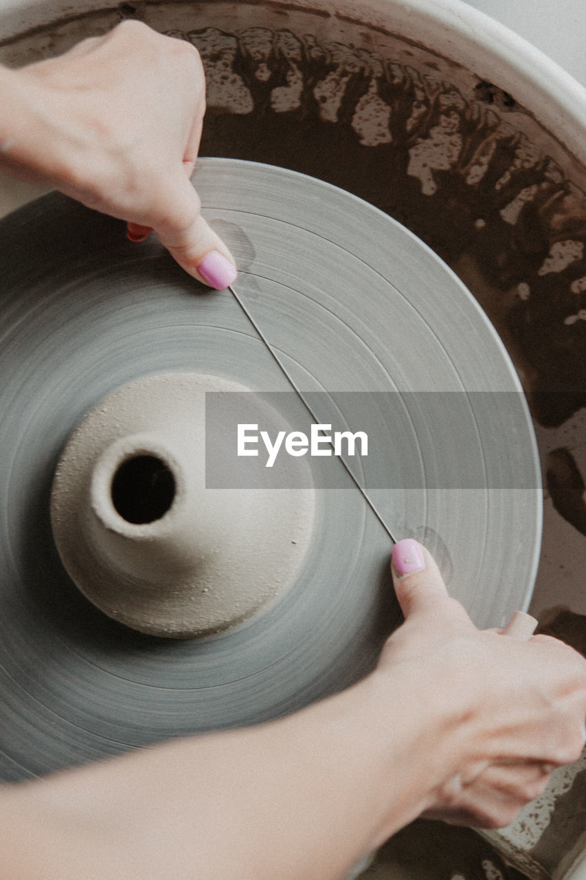 Midsection of woman at pottery workshop