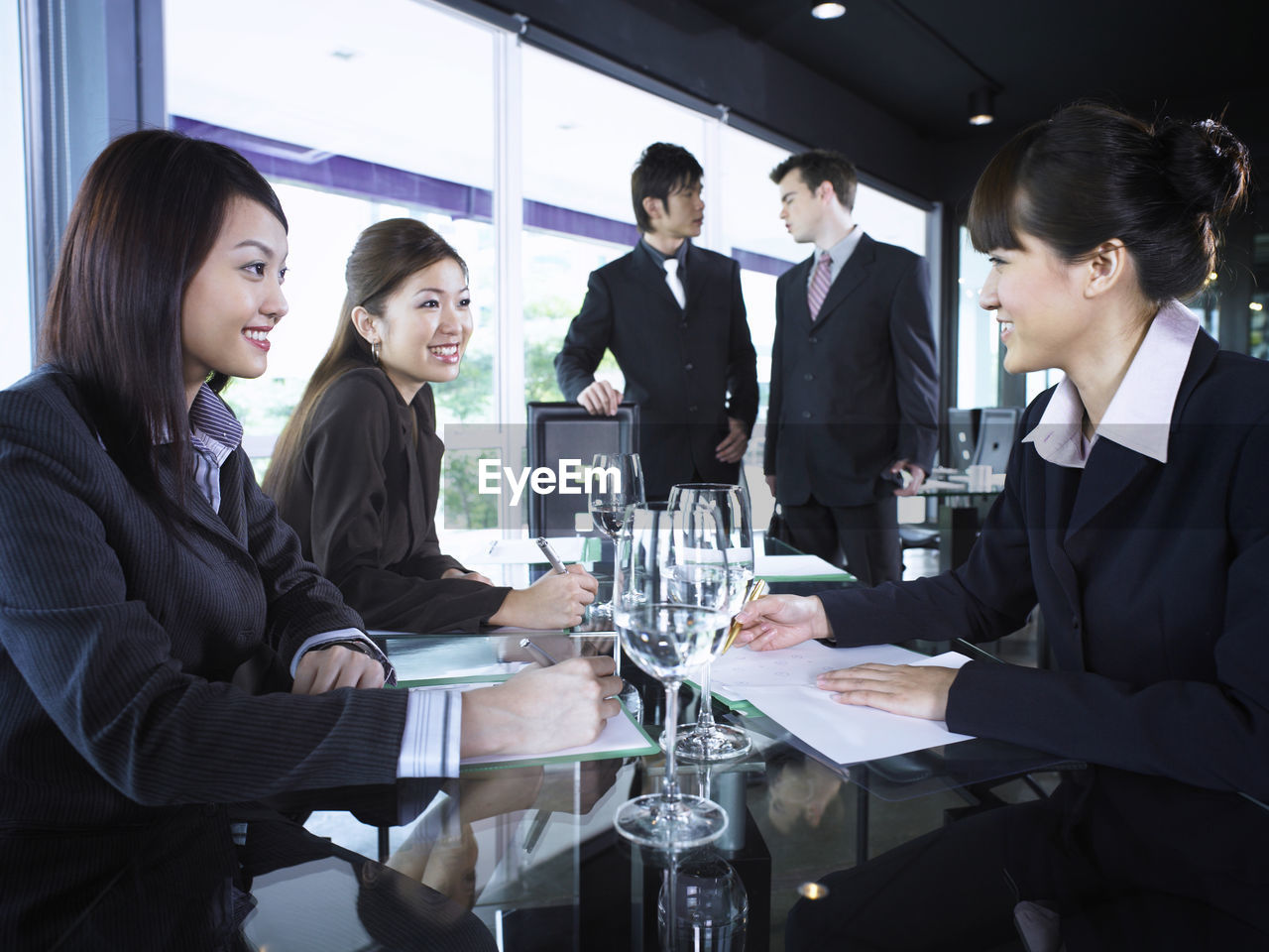 Smiling colleagues with drinks at restaurant during meeting