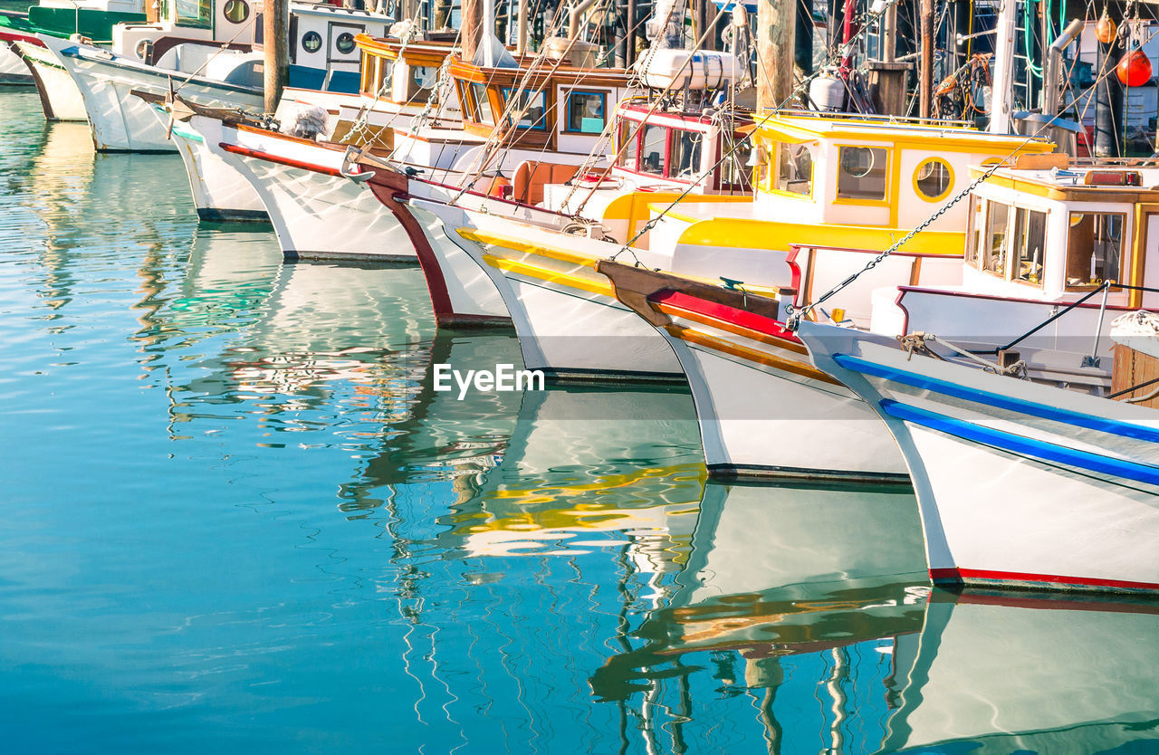 Boats moored at harbor