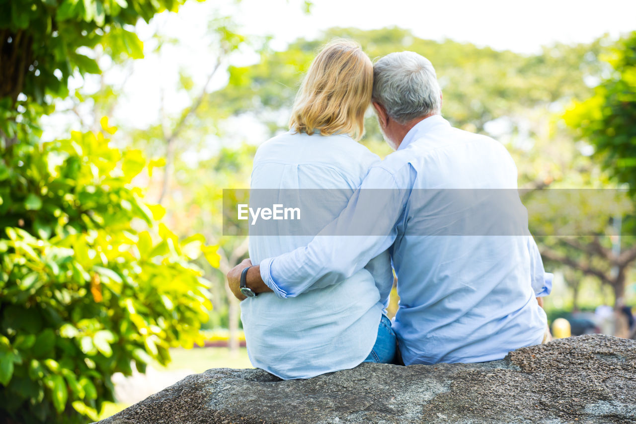 Rear view of senior couple sitting outdoors