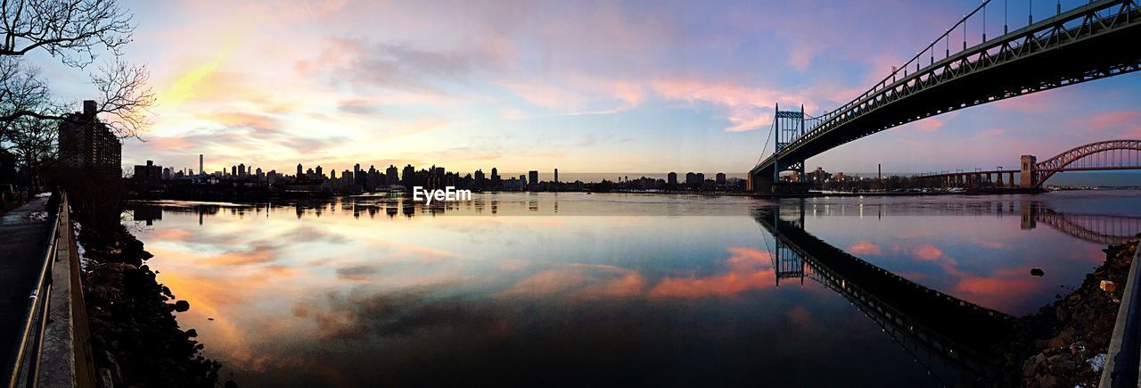 Panoramic shot of river and cityscape during sunset