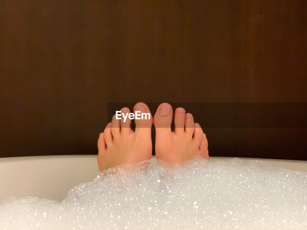 Low section of woman in bathtub