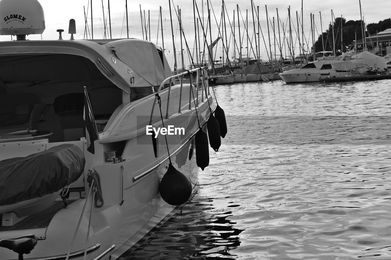 SAILBOAT MOORED AT HARBOR