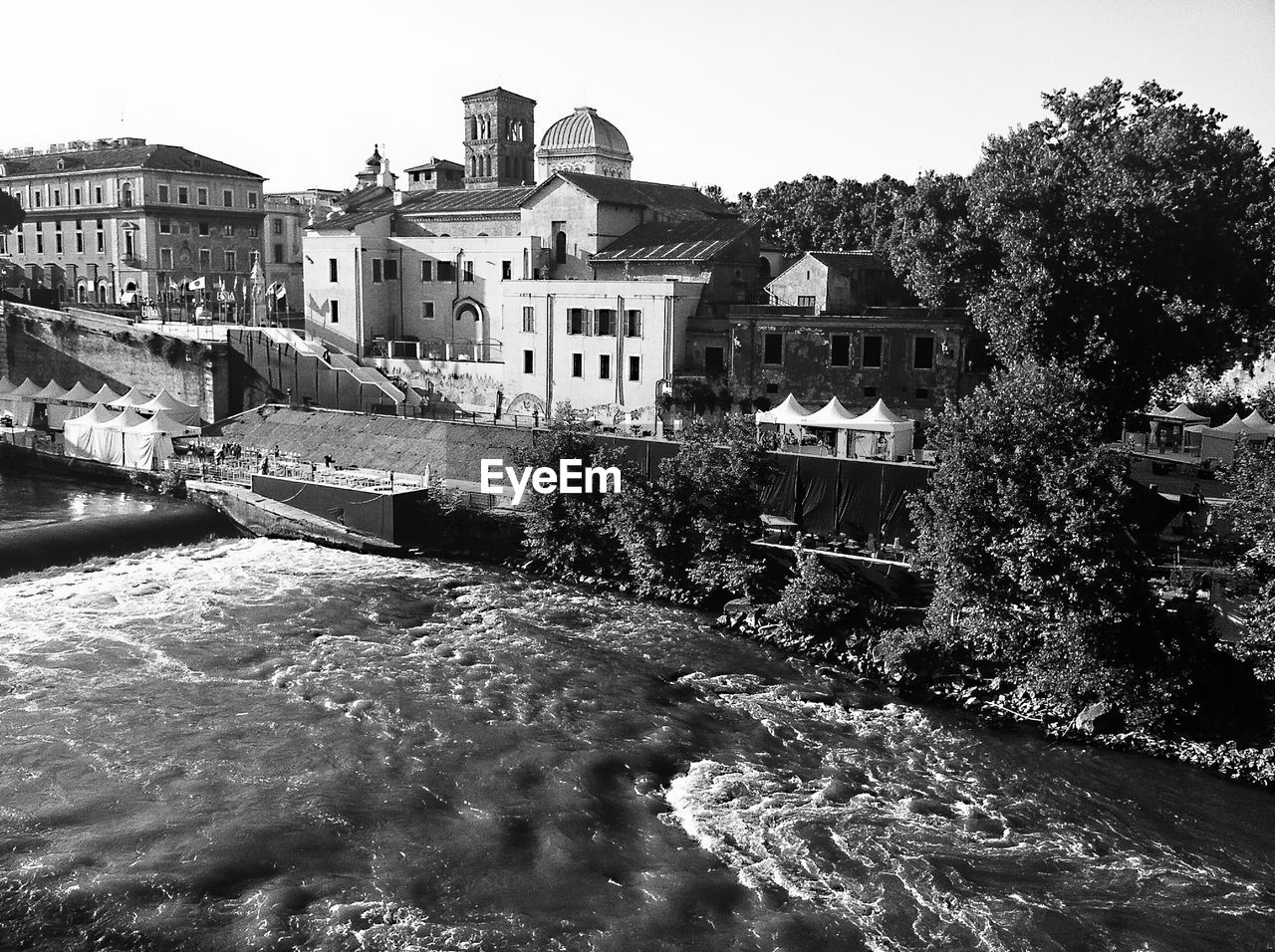 River flowing by buildings in city