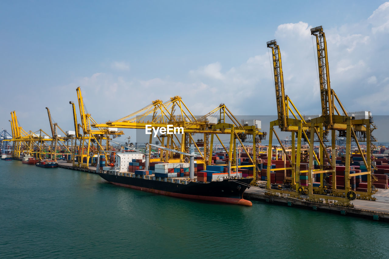 Containers ship and shipping ports logistic freight load unloading by crane forwarding industry 