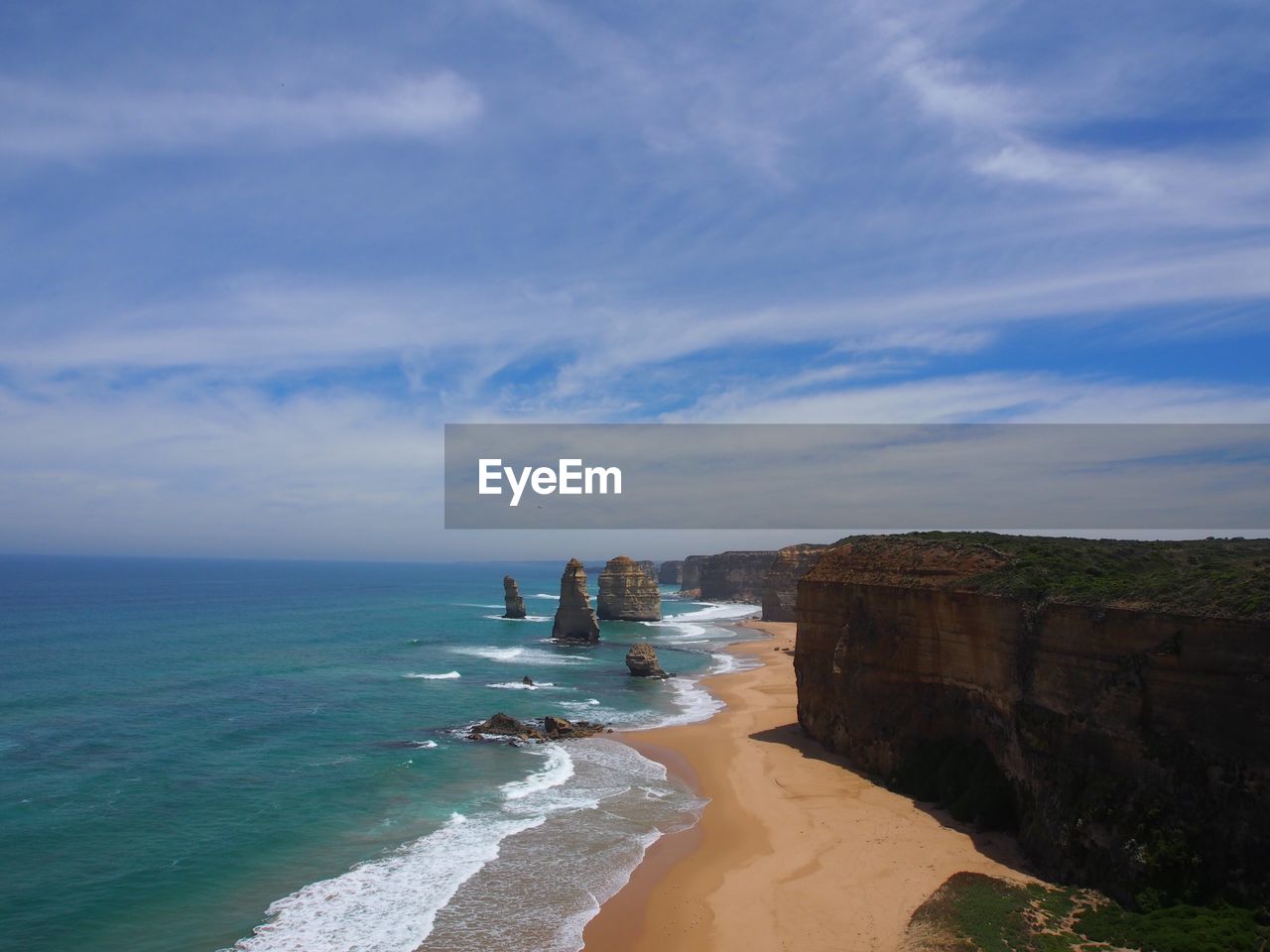 View of beach against cloudy sky