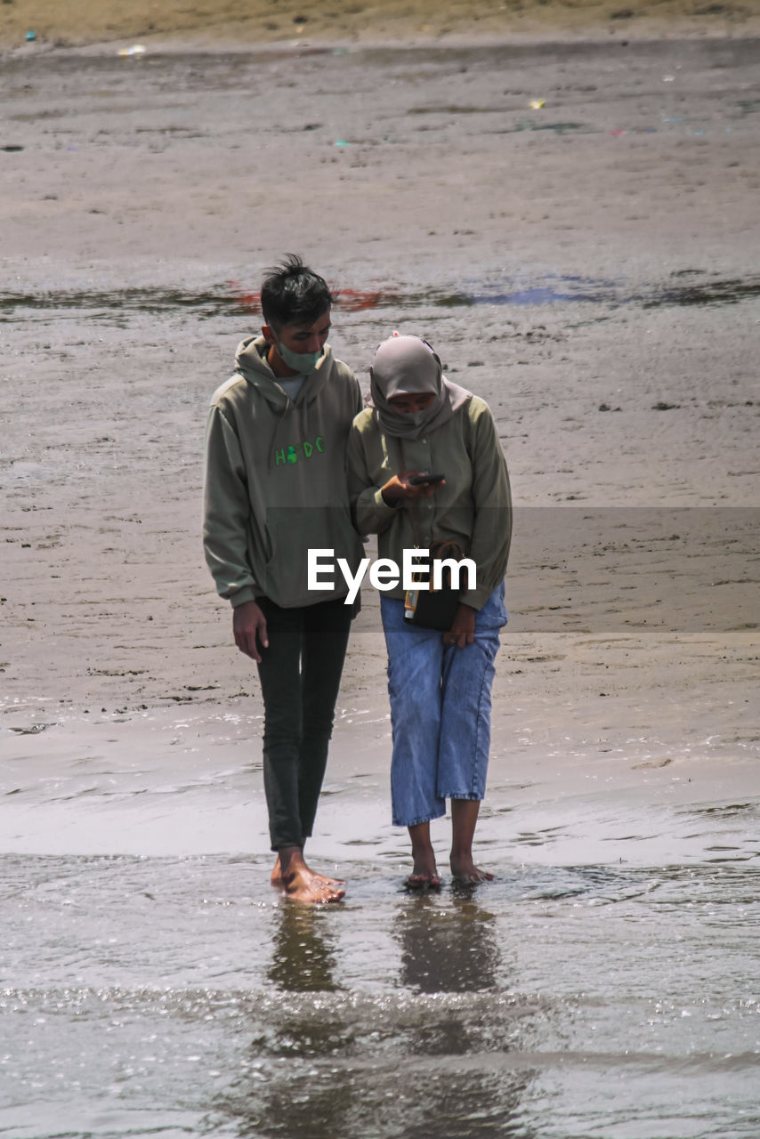 Young men and women are making love on the beach