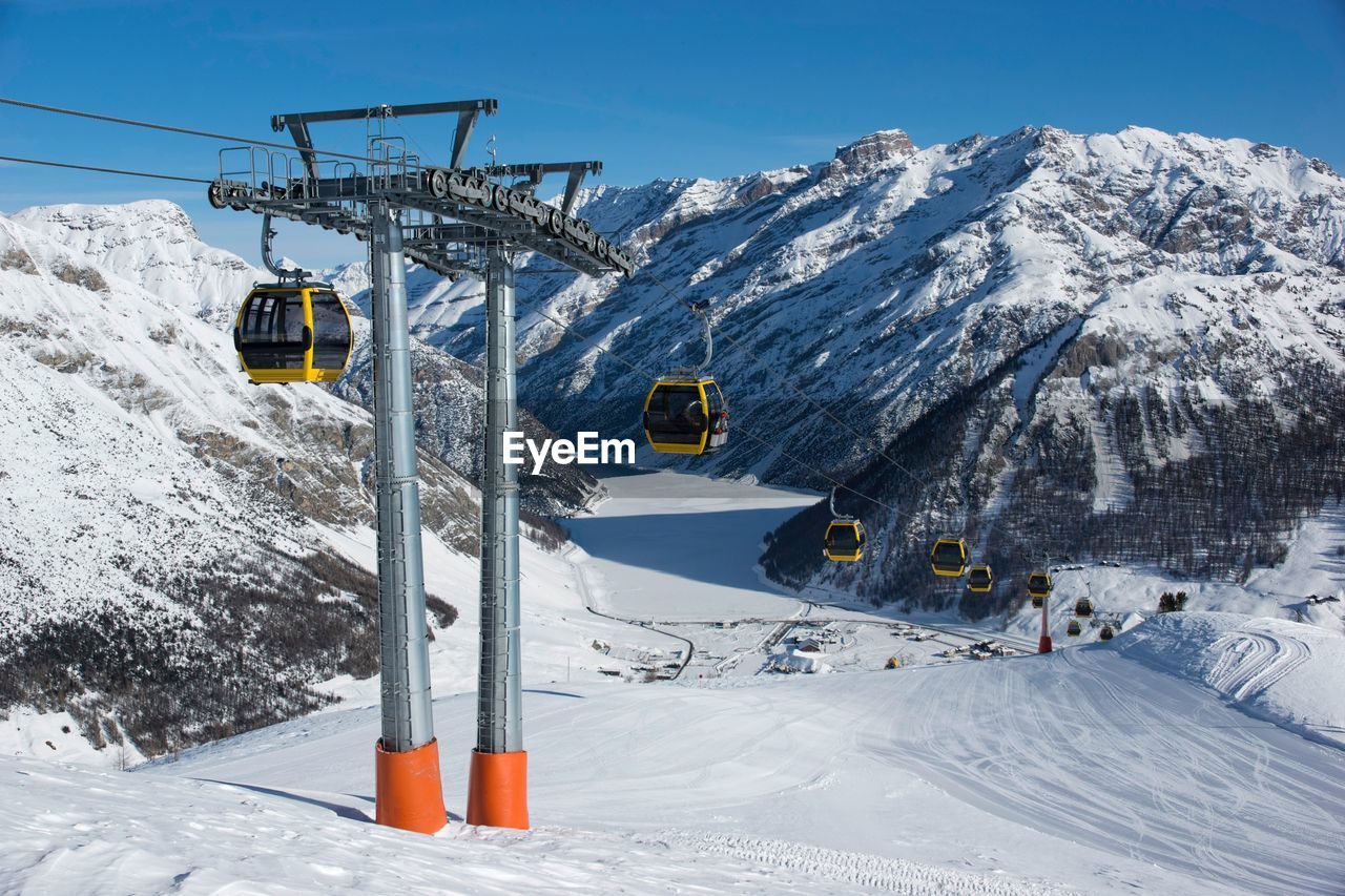 Overhead cable cars on snow covered field 