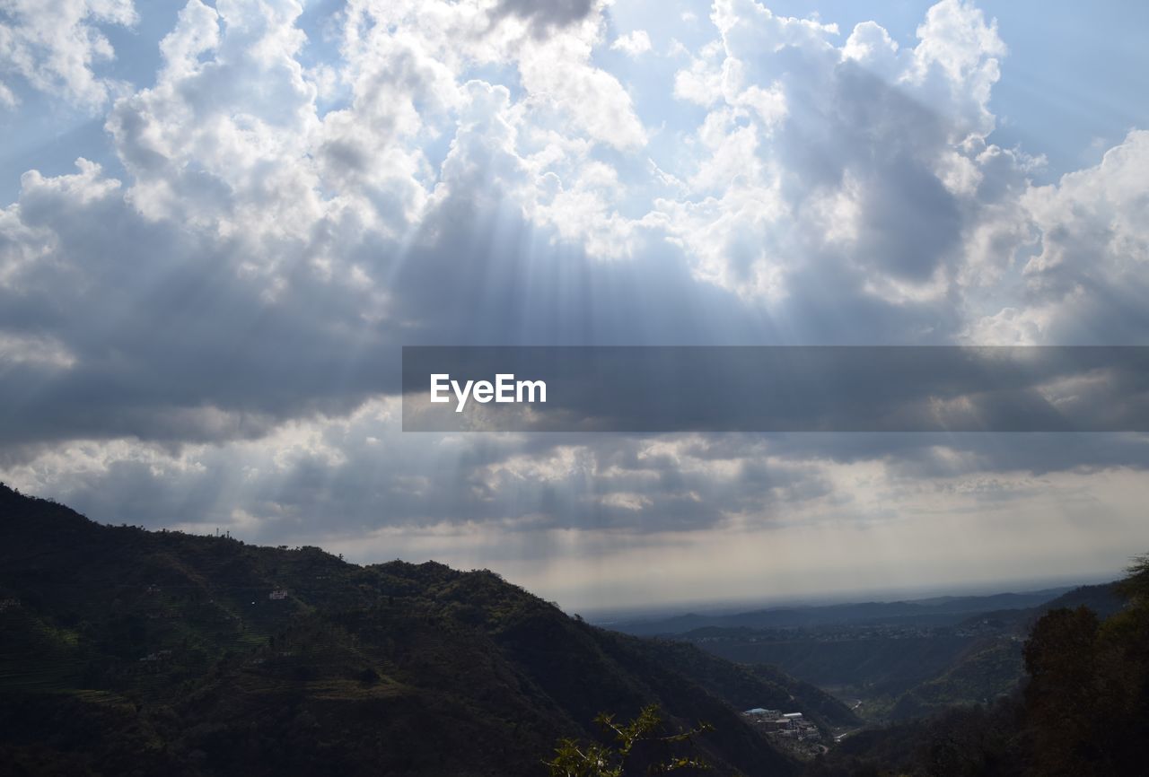 PANORAMIC SHOT OF COUNTRYSIDE LANDSCAPE AGAINST CLOUDS