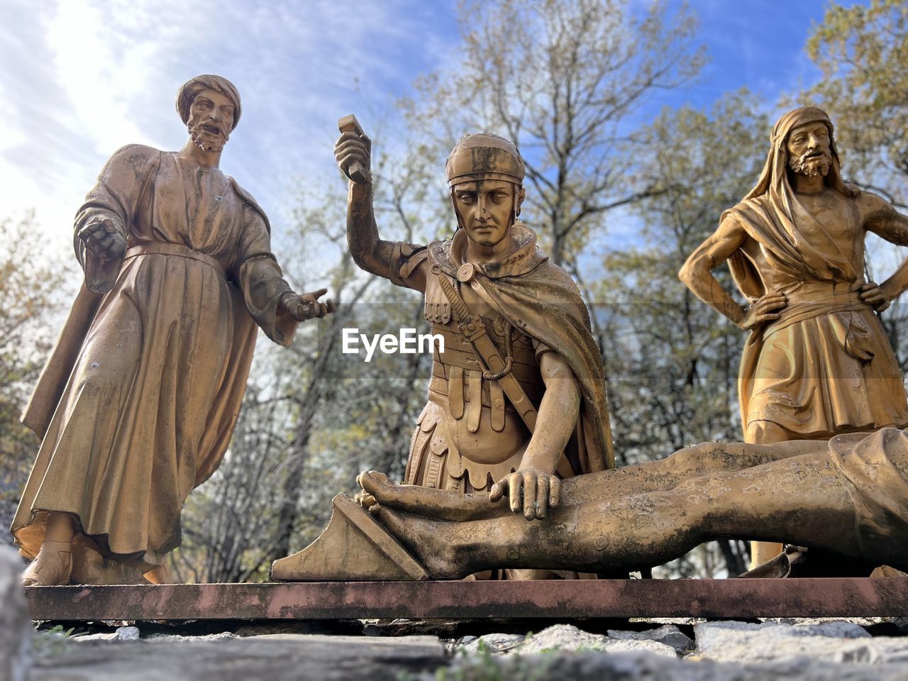 sculpture, statue, ancient history, architecture, art, human representation, religion, history, monument, the past, nature, temple, male likeness, craft, belief, sky, representation, spirituality, tree, travel destinations, no people, outdoors, low angle view, travel, day