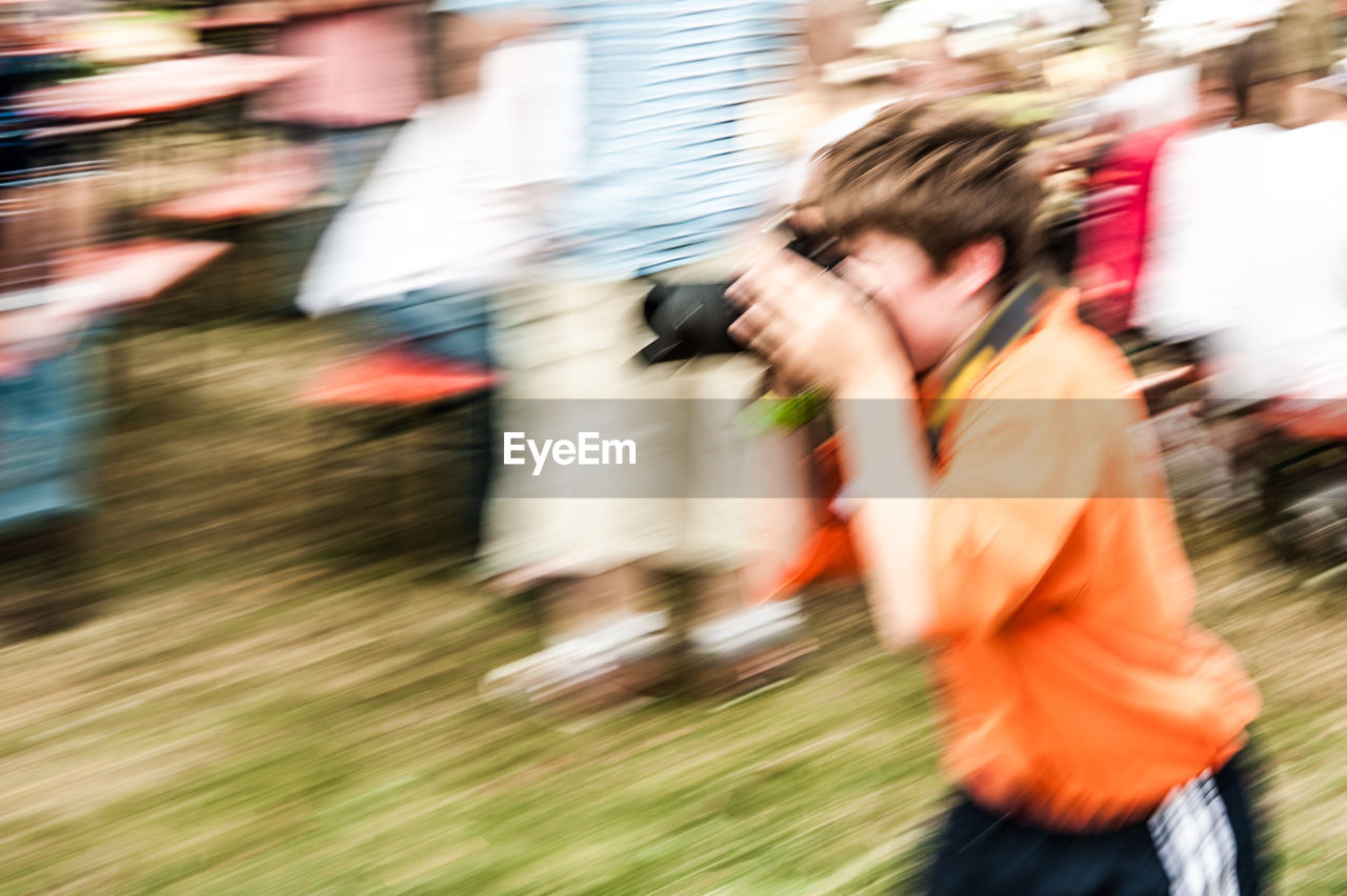 BLURRED MOTION OF PEOPLE ON STREET