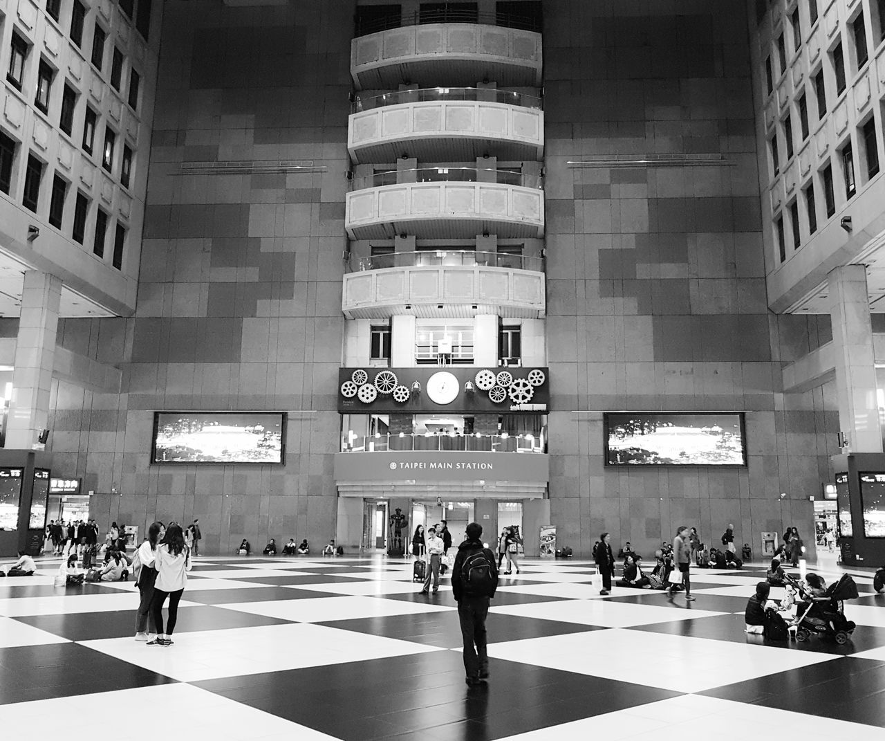 Flow of people moving through the common area to their destinations at Taipei Station The Street Photographer - 2018 EyeEm Awards Adult Architecture Building Building Exterior Built Structure City Communication Crowd Group Of People Large Group Of People Lifestyles Men Outdoors Real People Sign Symbol Text Transportation Walking Women The Traveler - 2018 EyeEm Awards