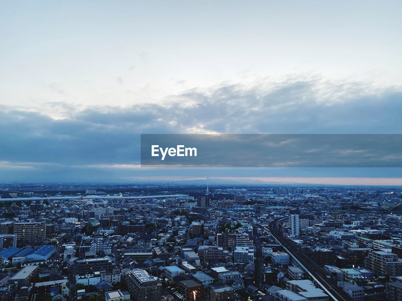 High angle view of city against cloudy sky