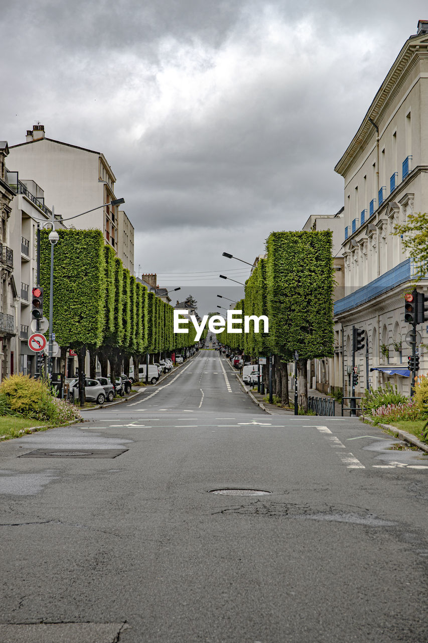 ROAD BY BUILDINGS AGAINST SKY