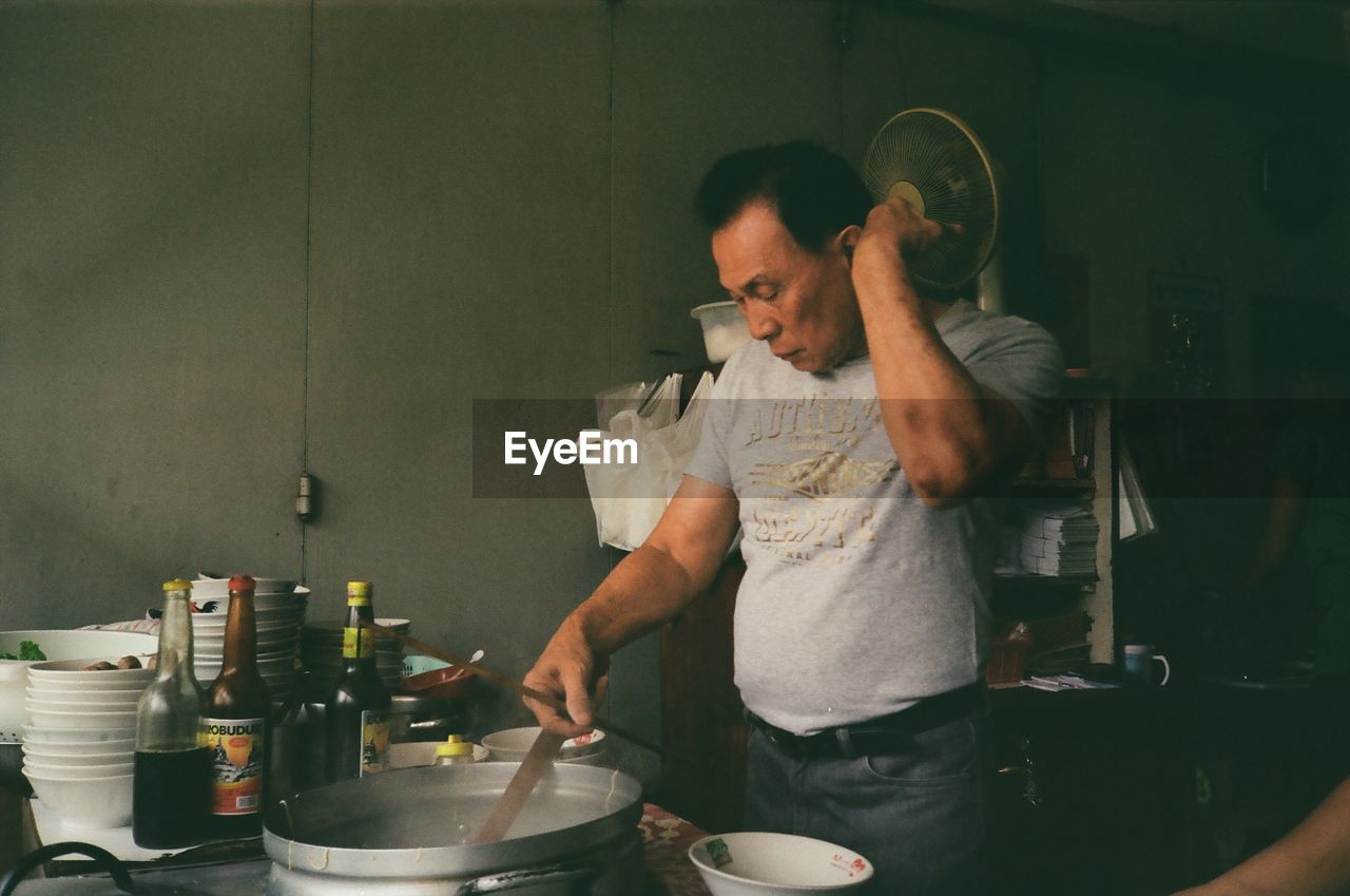 MAN PREPARING FOOD