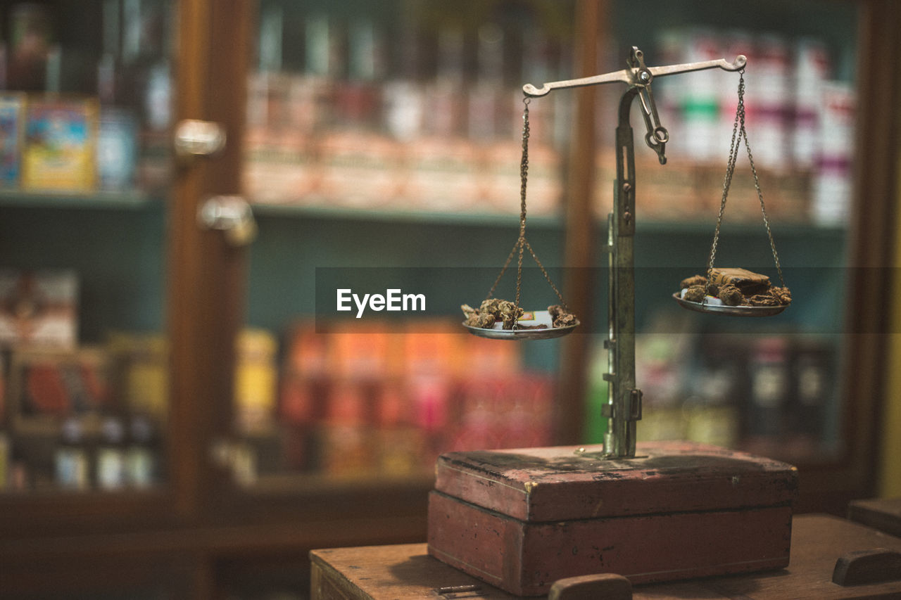 CLOSE-UP OF ELECTRIC LAMP HANGING ON TABLE