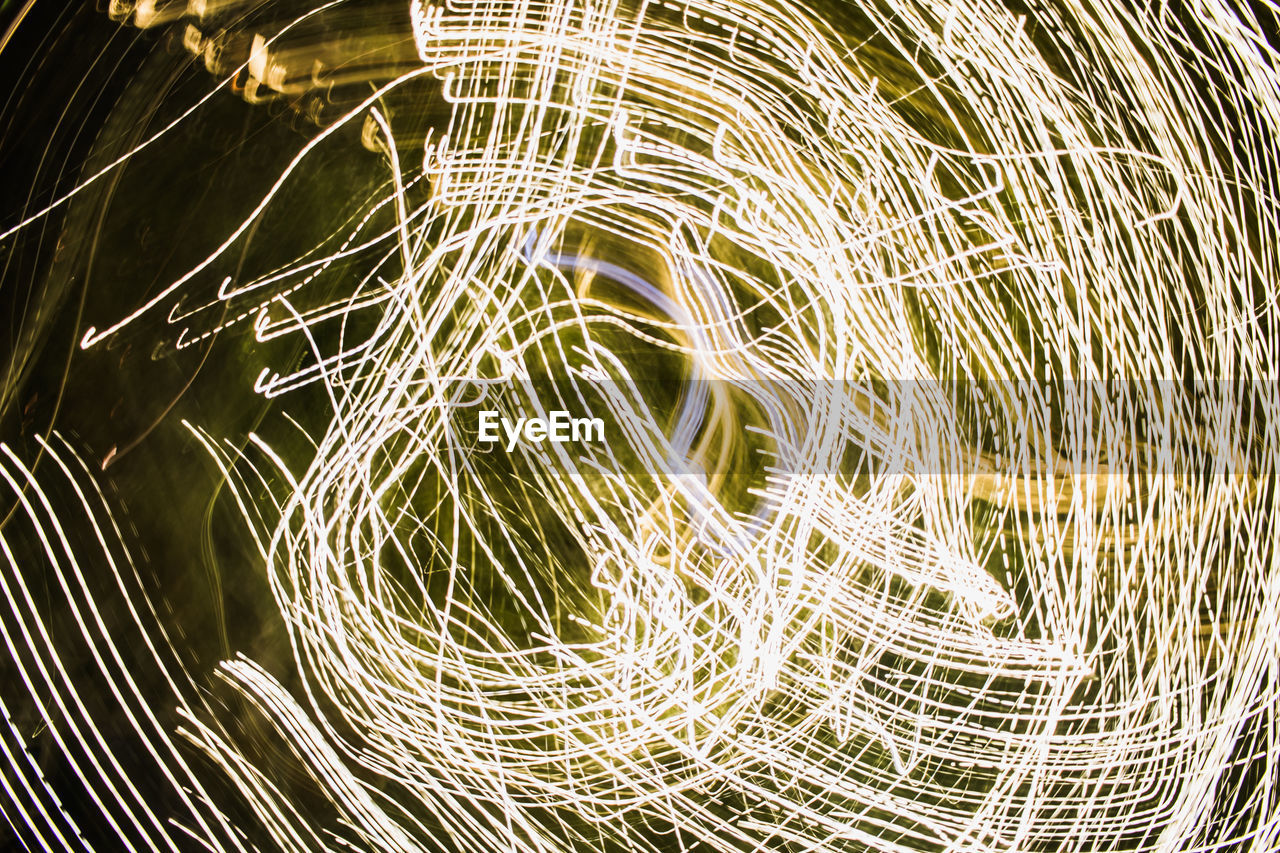 FULL FRAME SHOT OF LIGHT TRAILS ON NIGHT