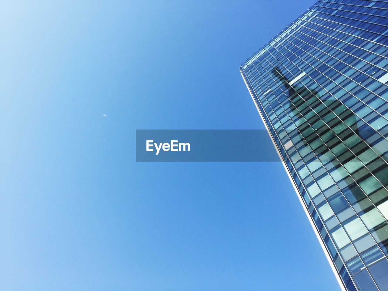 LOW ANGLE VIEW OF SKYSCRAPERS AGAINST BLUE SKY