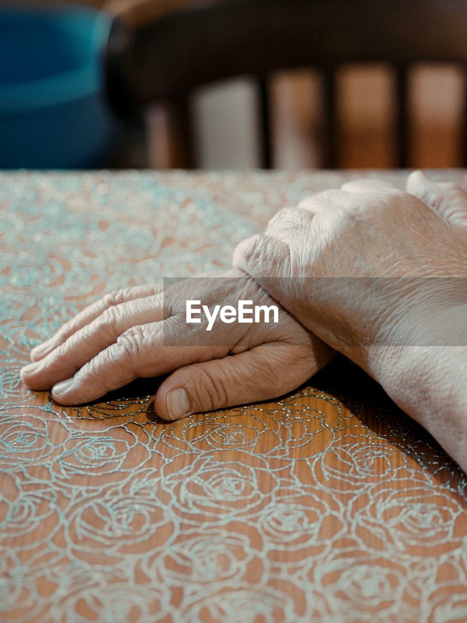 hand, adult, one person, pattern, indoors, furniture, senior adult, finger, limb, close-up, arm, human leg, flooring, women, lifestyles, focus on foreground, relaxation