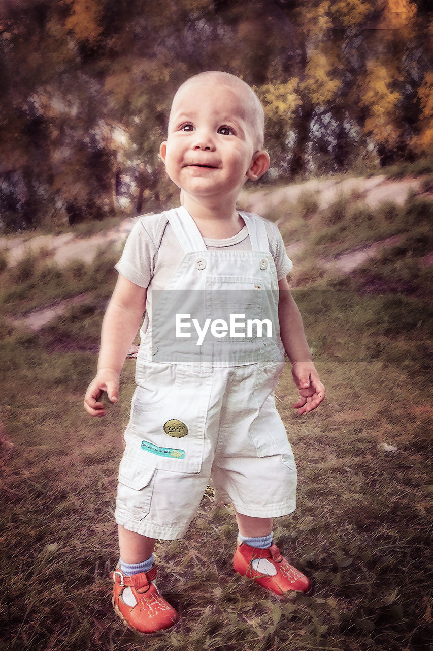 Portrait of cute girl standing on field