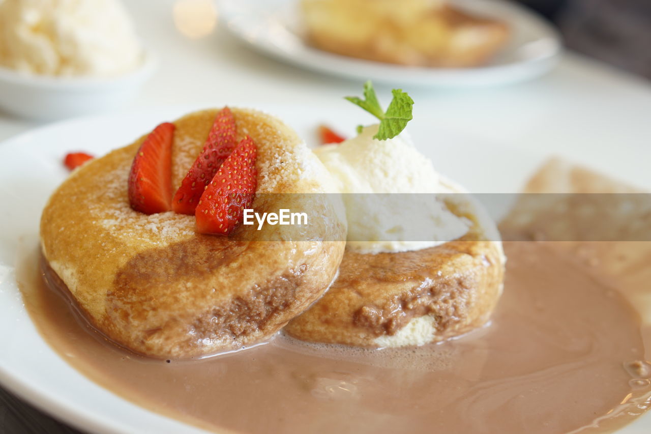 CLOSE-UP OF CAKE SERVED ON TABLE