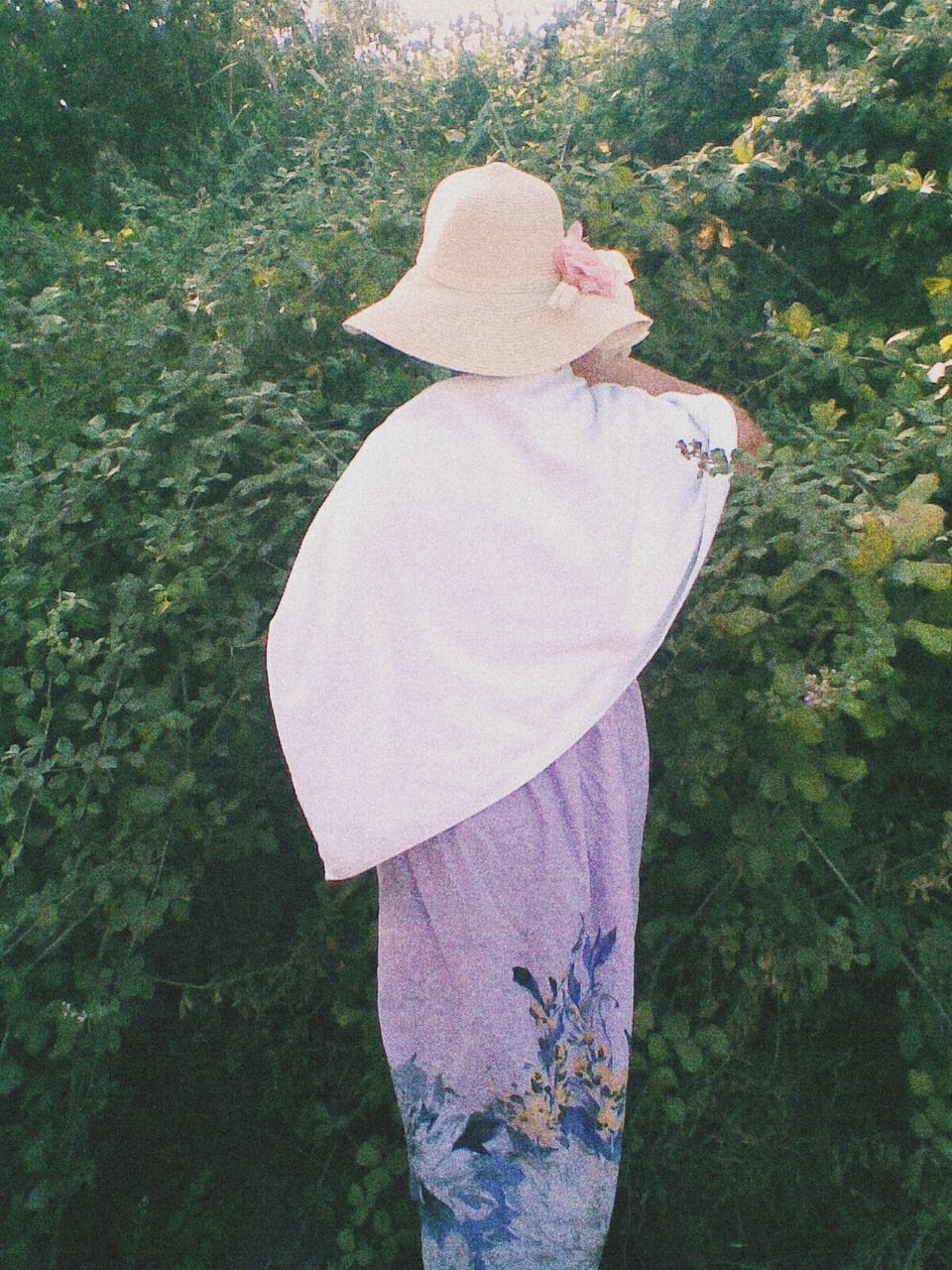 Woman wearing hat in garden