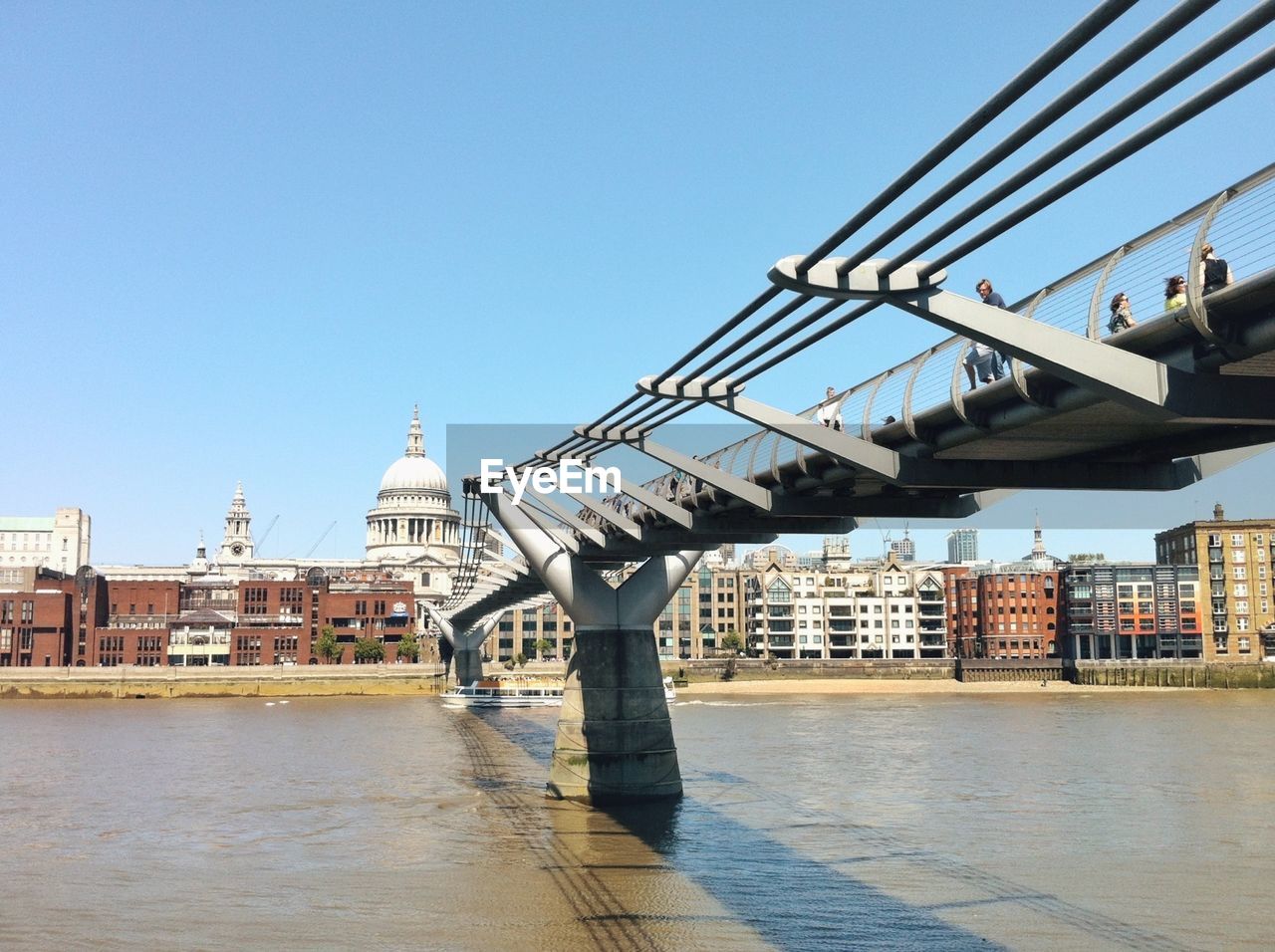 Millennium bridge over river with st pauls cathedral in background