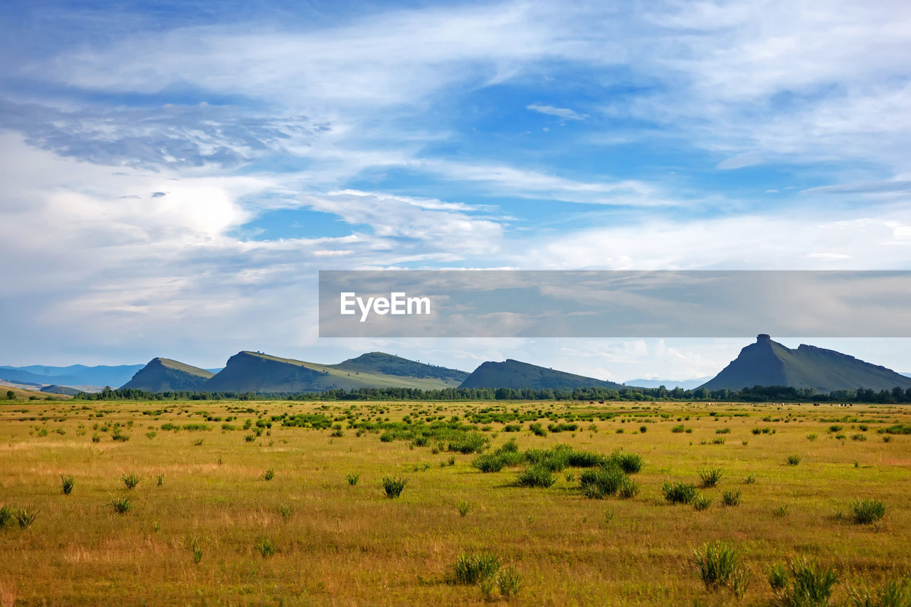 View of the mountain range sunduki, khakassia, russia. sky with clouds over mountains in the steppe