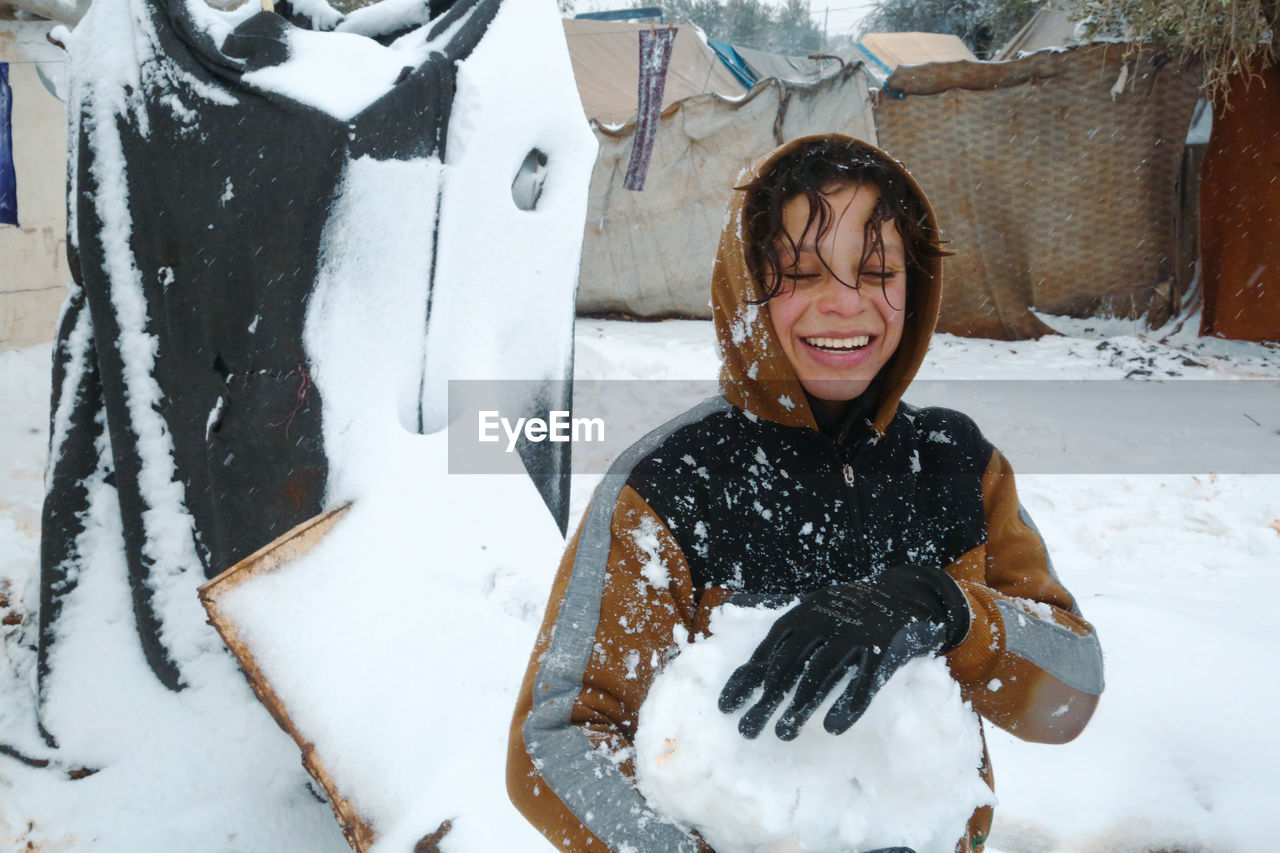 Syrian refugee children playing in the snow that fell on the camp near the syrian-turkish border