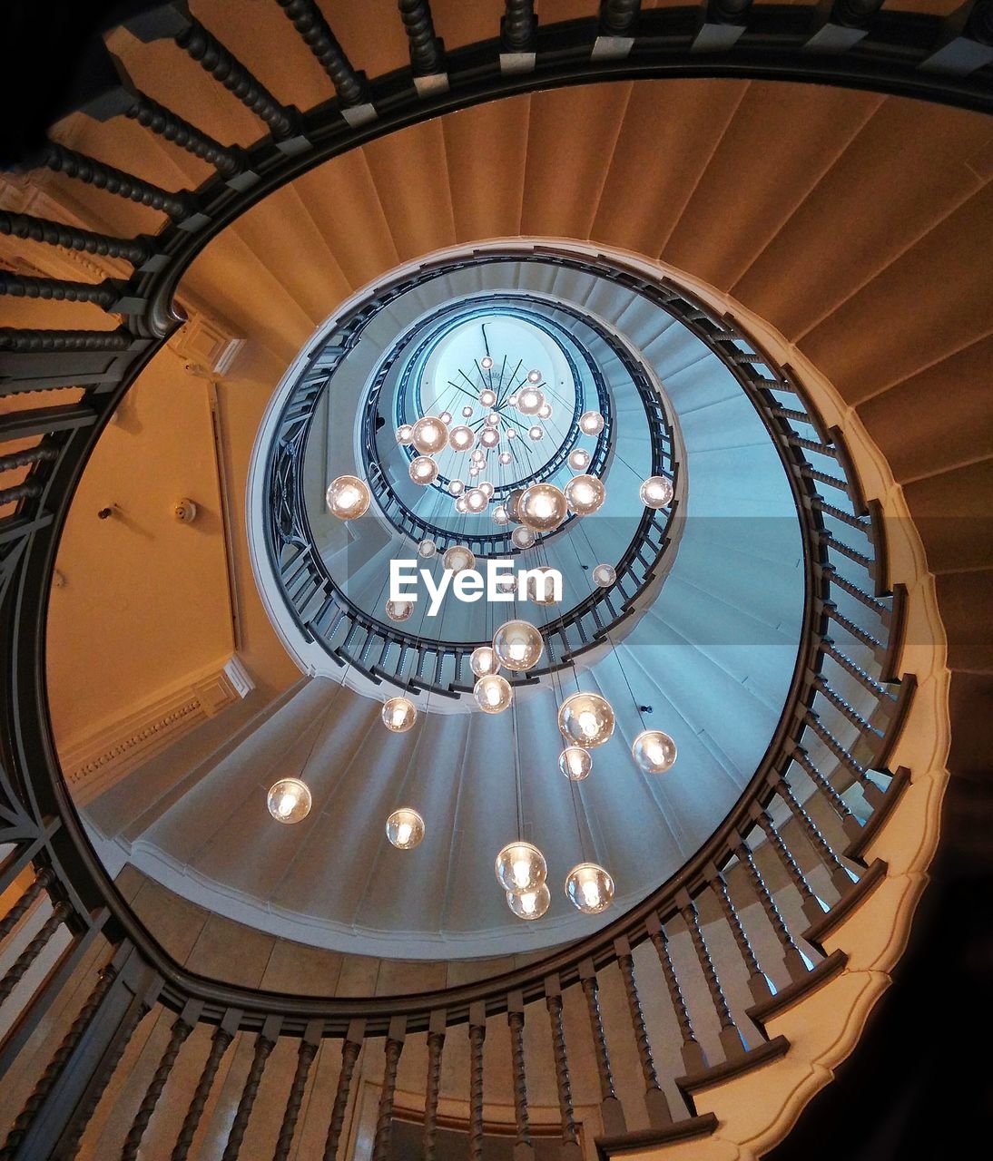 Directly below shot of decorations amidst spiral staircases in building