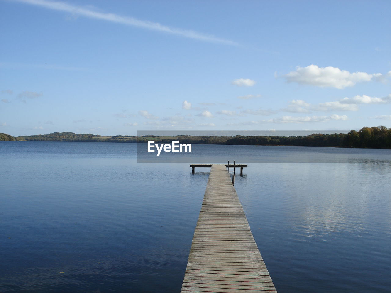 Pier over lake against sky