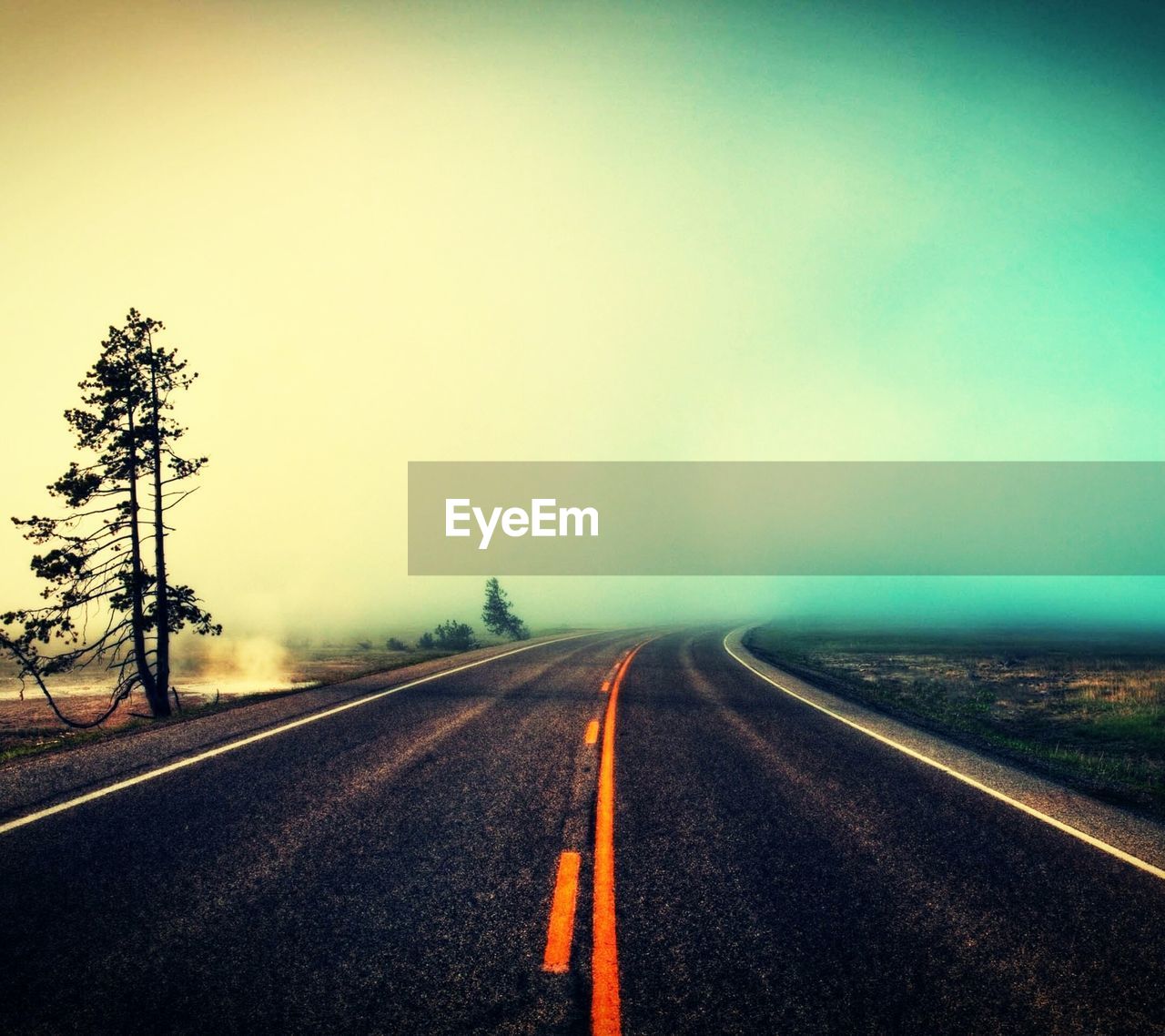 EMPTY ROAD LEADING TOWARDS DRAMATIC SKY