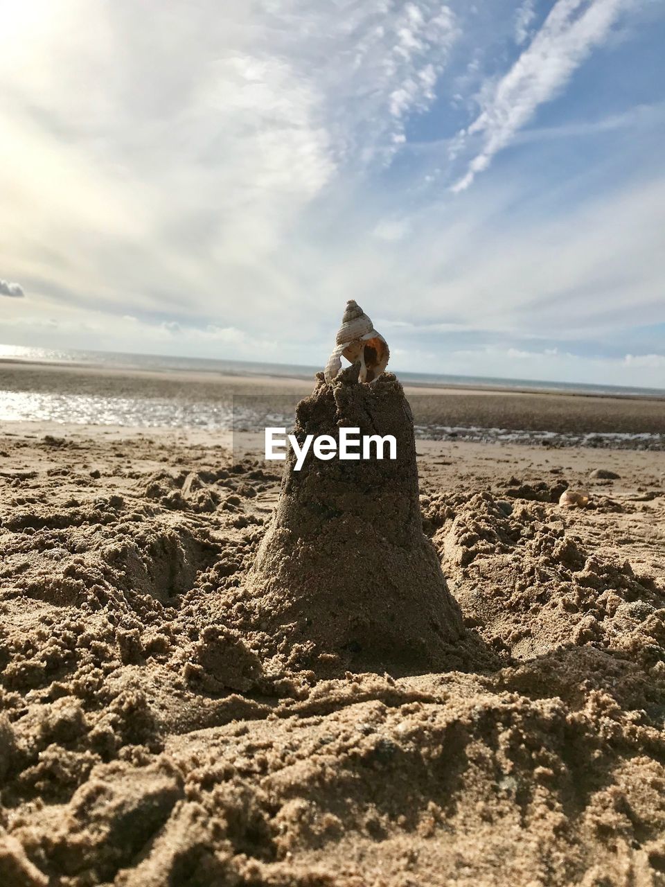 Scenic view of rocks on beach against sky