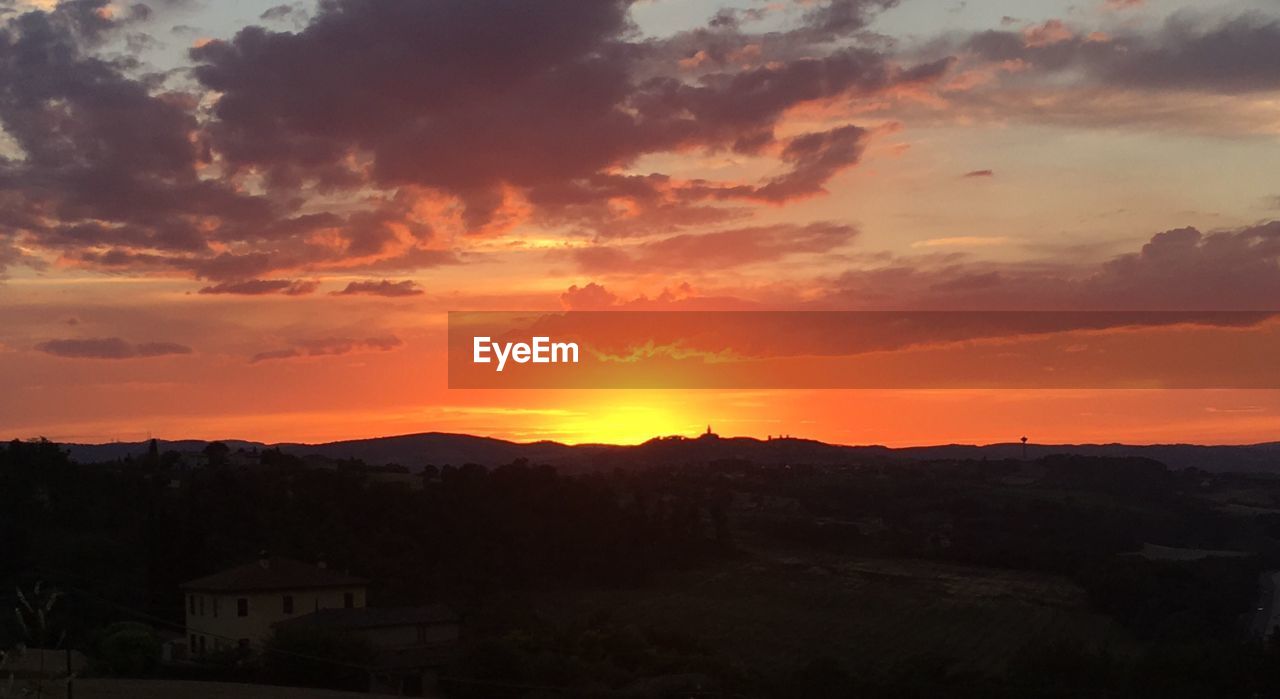 SCENIC VIEW OF MOUNTAINS AT SUNSET