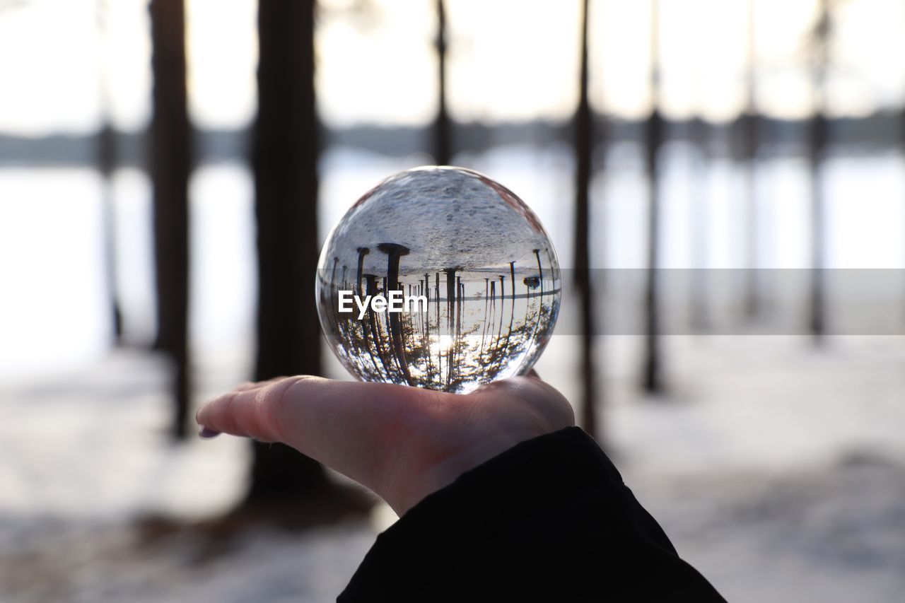 Close-up of hand holding crystal ball