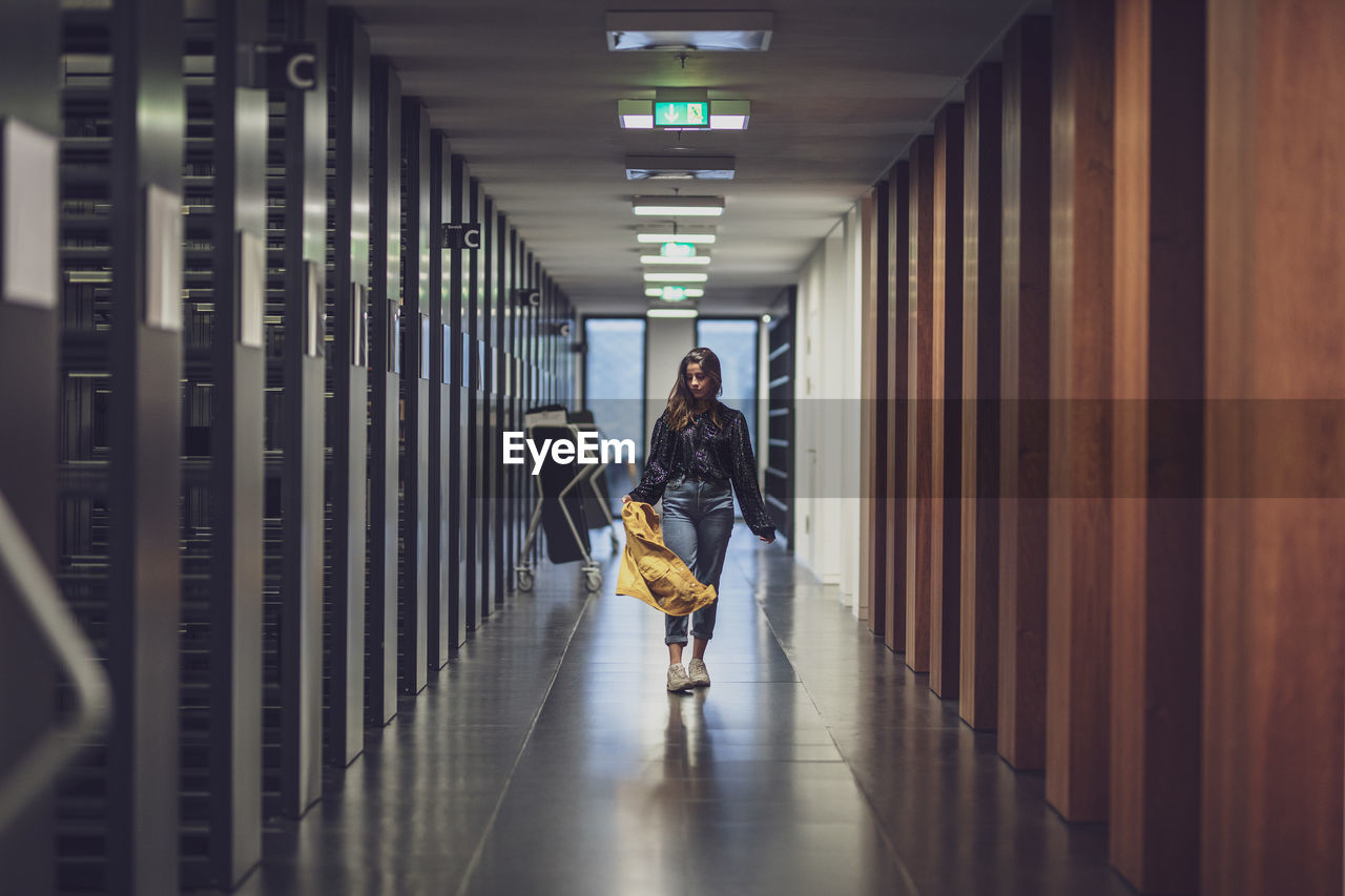 Young woman walking indoors