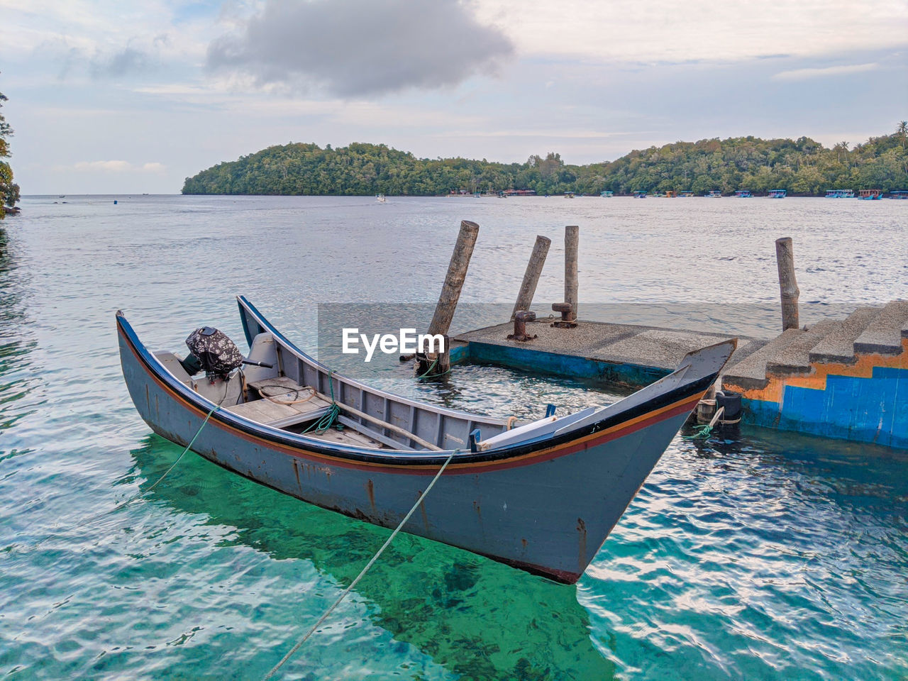 Boat moored in sea against sky