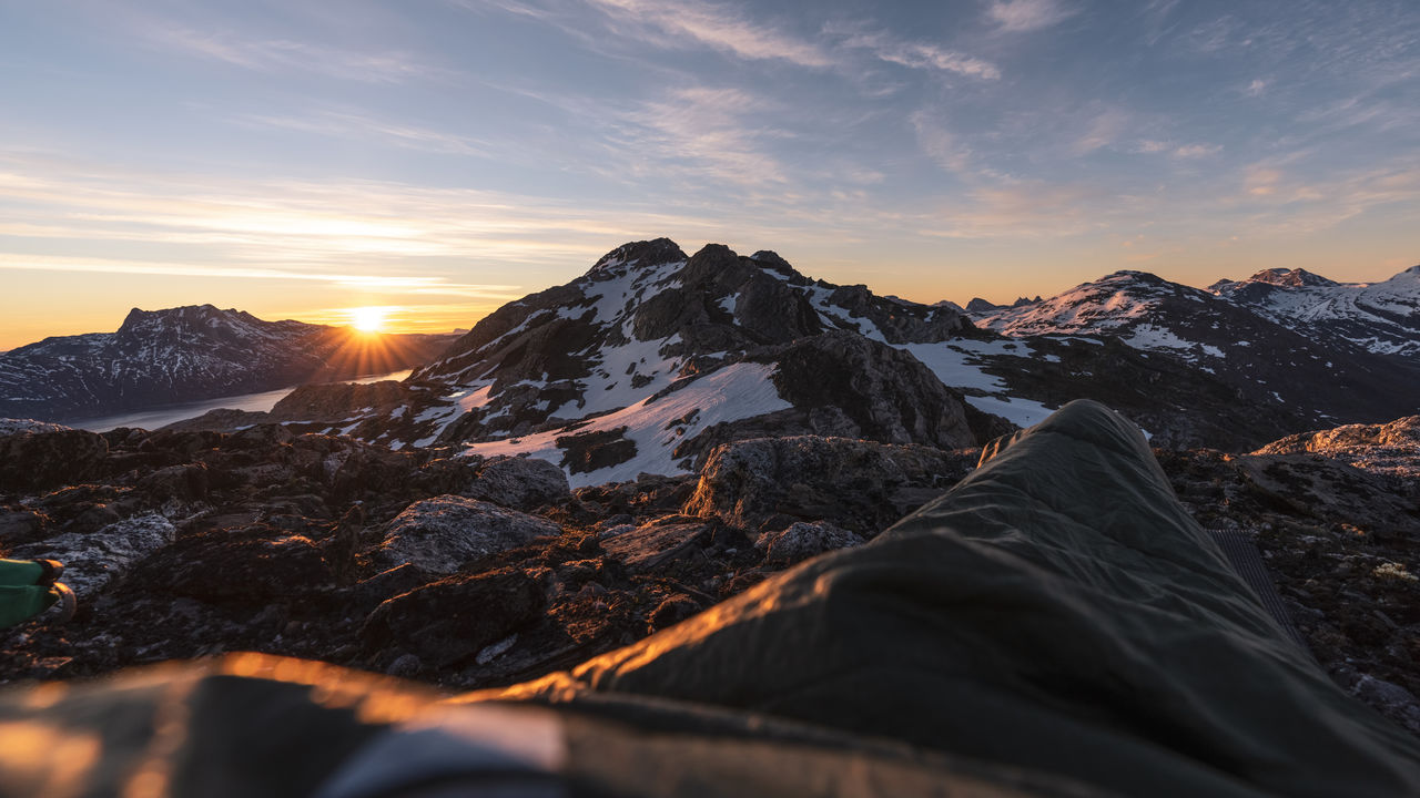 Scenic view of snowcapped mountains against sky during sunset