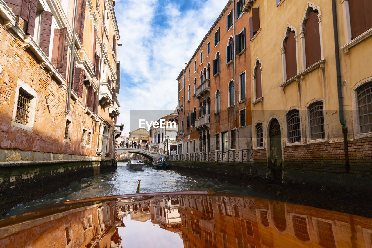 CANAL AMIDST BUILDINGS IN CITY