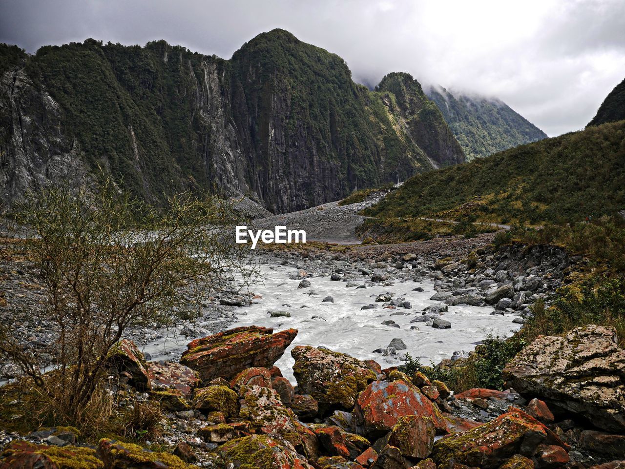 Scenic view of rocks in mountains against sky