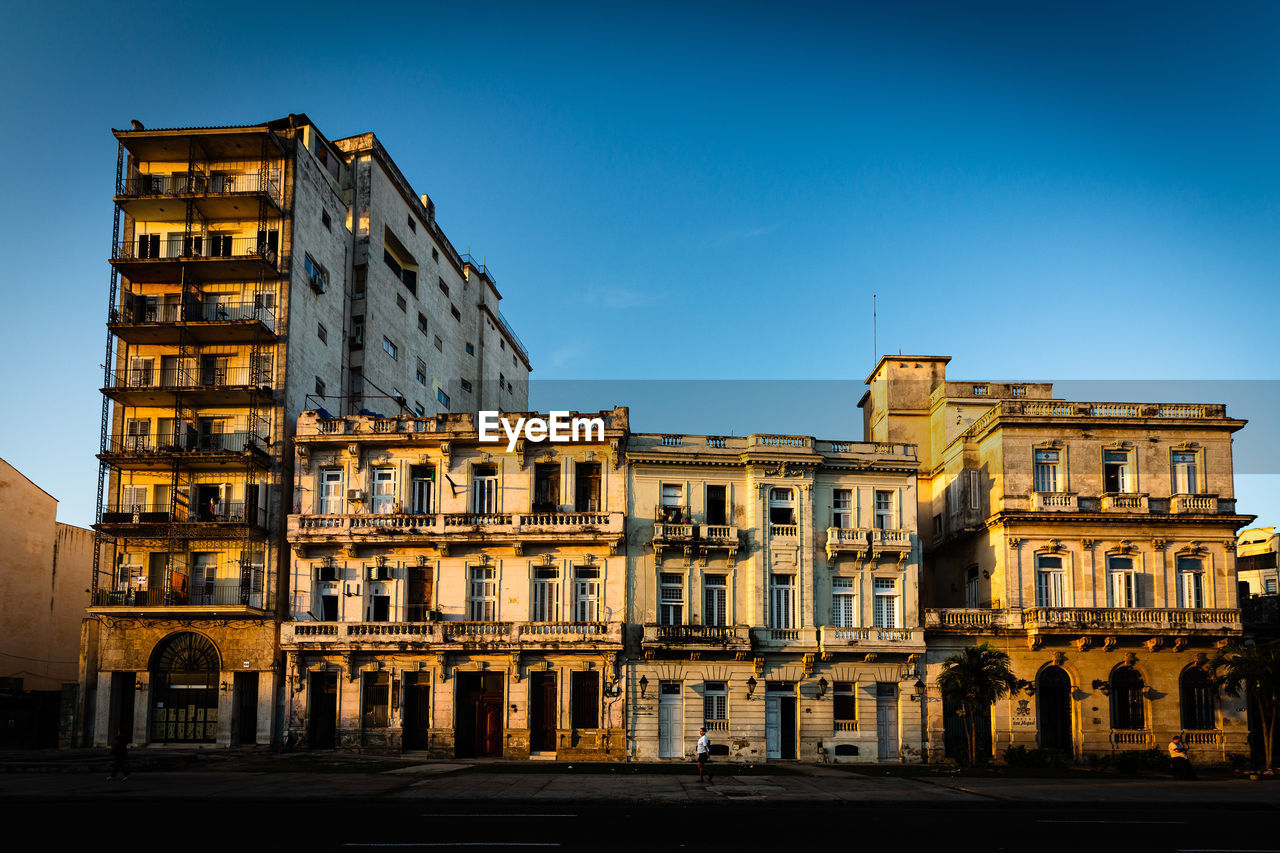 Low angle view of buildings against blue sky