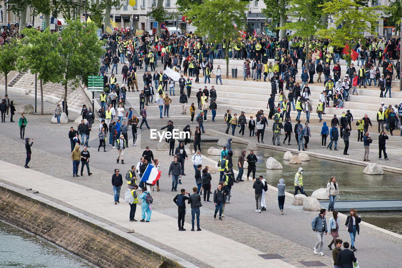 HIGH ANGLE VIEW OF PEOPLE WALKING ON STREET IN CITY