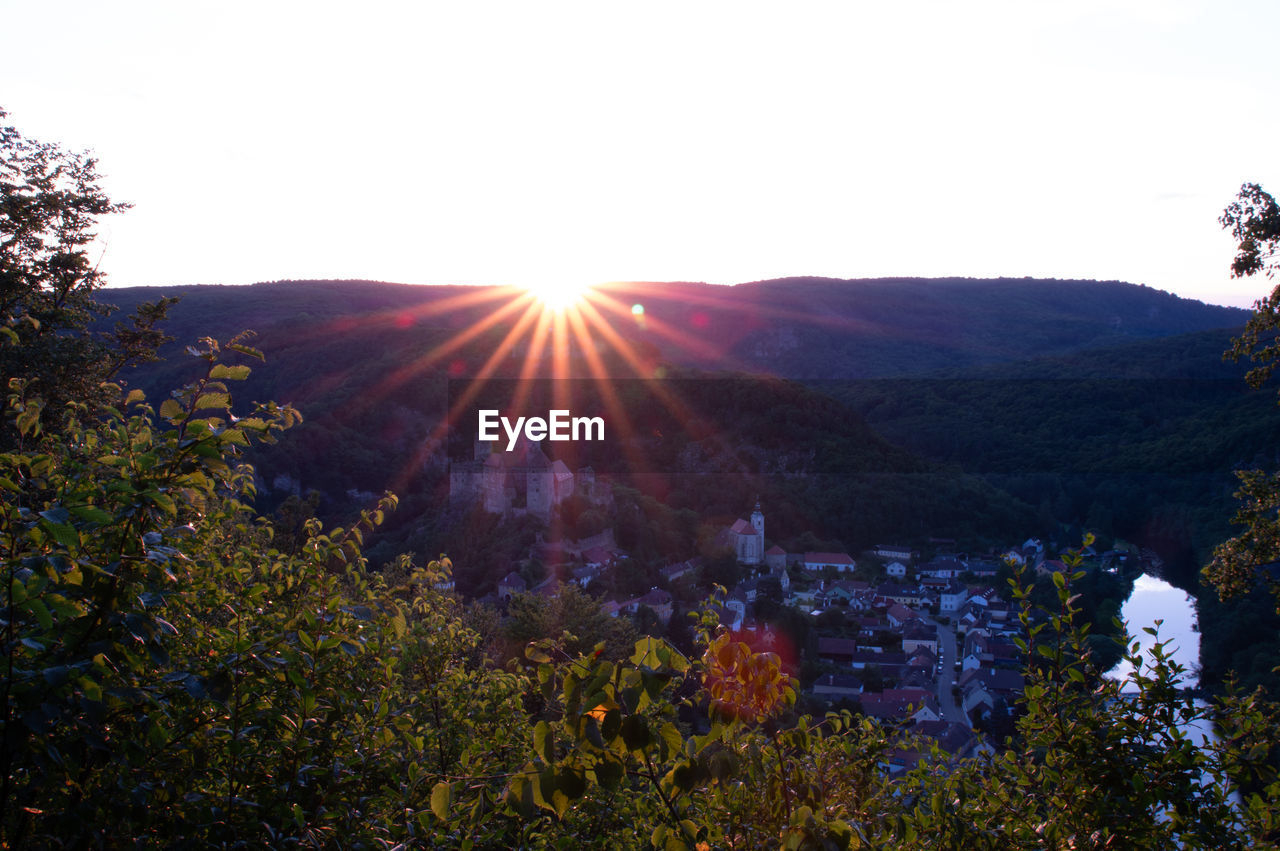 sky, plant, beauty in nature, nature, scenics - nature, mountain, landscape, sunlight, sun, tree, environment, lens flare, sunbeam, tranquility, no people, land, autumn, tranquil scene, flower, non-urban scene, sunset, growth, outdoors, wilderness, idyllic, clear sky, day, leaf, mountain range, back lit